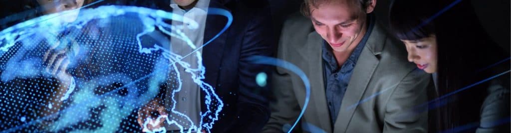 Professionals analyzing a digital holographic world map, representing global investment opportunities and collaboration, illustrating the concept of the Refundable Investment Credit Grant on FI Group Singapore’s website.