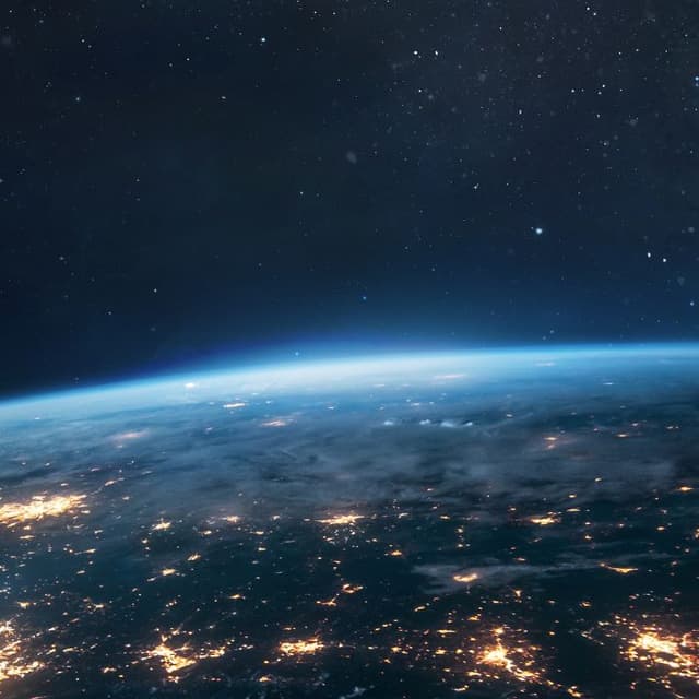 View of Earth from space with illuminated city lights, representing global innovation and R&D tax incentives.